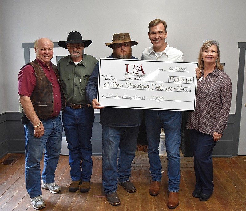 The Custom Knife Collectors Association recently donated $15,000 to the newly renovated campus of the University of Arkansas Hope-Texarkana's James Black School of Bladesmithing and Historic Trades. Shown from left are Joe Rudé, CKCA board member; Jerry Fisk, CKCA vice president; Ryan Hays, CKCA president; Chris Thomason, UAHT chancellor; and Laura Clark, UAHT vice chancellor for academics. (Submitted photo)
