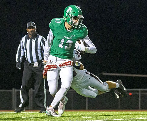 Blair Oaks wide receiver Carson Prenger tries to shake off the tackle attempt by Southern Boone defensive back Blake Dapkus after hauling in a catch during last Friday's game at the Falcon Athletic Complex in Wardsville.