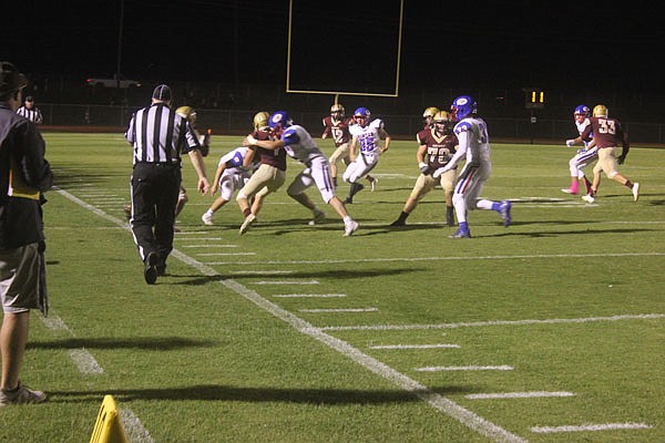 The California defense swarms to bring down an Eldon Mustang ball carrier during a game earlier this month at Eldon.