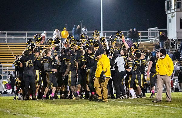 Members of the Fulton Hornets celebrate last Friday after their 62-14 romp against Southeast at Robert E. Fisher Stadium in Fulton. The Hornets travel to rival Mexico tonight for the annual Highway 54 Bowl.