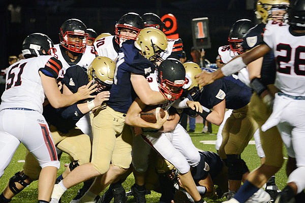 The Helias defense stuffs a run attempt by Hannibal during the season opener at Ray Hentges Stadium. The run defense of the Crusaders figures to be tested in tonight's home game by the Rock Bridge Bruins.