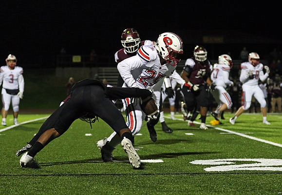 Jefferson City receiver Nick Williams is able to hold onto the football as De Smet's Anthony Grant tries to strip it away during Friday night's game in St. Louis. 