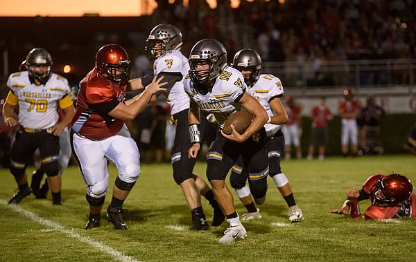 Versailles quarterback Coby Williams gets flushed from the pocket and scrambles for a first down during a game earlier this season against Southern Boone in Ashland.