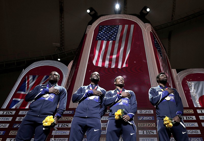 Gold medalists from left, Christian Coleman, Justin Gatlin, Michael Rodgers and Noah Lyles of the United States take part in the medal ceremony for the men's 4x100 meter relay at the World Athletics Championships in Doha, Qatar, Sunday, Oct. 6, 2019. (AP Photo/Nariman El-Mofty)