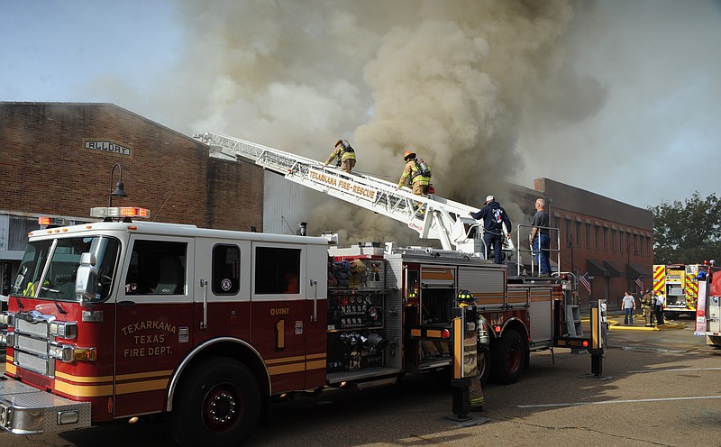 Firefighters battle a blaze Thursday in downtown Atlanta, Texas. The fire caused the complete loss of three buildings and water and smoke damage in another.