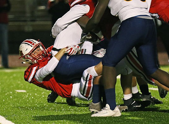 Jefferson City linebacker Will Berendzen makes a tackle during Friday night's game against Battle at Adkins Stadium.