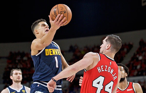 Nuggets forward Michael Porter Jr. shoots over Trail Blazers forward Mario Hezonja during a preseason game earlier this month in Portland, Ore. Porter, a former Missouri Tiger, enters the season healthy after sitting out his rookie year.