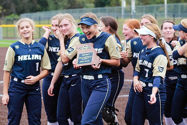 Rylee Kolb holds the plaque as the Helias Lady Crusaders celebrate Saturday after winning the Class 3 District 9 Tournament title with a 1-0 win against the Blair Oaks Lady Falcons in Ashland.