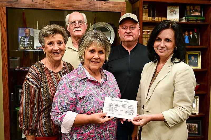 Miller County Judge Cathy Hardin Harrison, right, presents a grant check to Mary Hicks of the Doddridge Community Development Council for $46,400 at the Miller County Courthouse in Texarkana, Ark. Also pictured above are Wanda Peek, George Goynes, back left, and Sam Bumgardner.