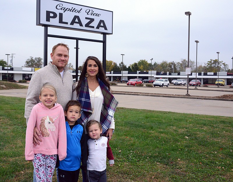 
Robby and Amanda Bax stand in front of the Capitol View Plaza sign with their children Olivia, Easton and Denver October 26, 2019 along Ellis Boulivard. The couple recently purchased what was formerly Ellis Plaza and have made several improvements. 