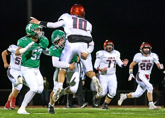 Blair Oaks defensive lineman Rylee Niekamp lifts Southern Boone quarterback Tyson Smith off the ground just as he fires a pass downfield during a game earlier this month at the Falcon Athletic Complex in Wardsville.
