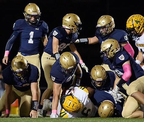 A host of Helias defenders stop Rock Bridge fullback Miles Cheatum at the line of scrimmage during last Friday night's game at Ray Hentges Stadium.