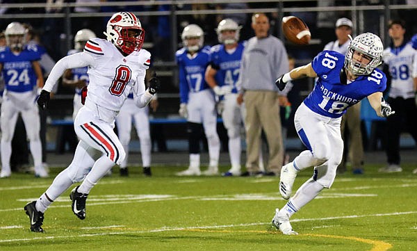 Rockhurst receiver Joseph Coit reaches for the pass as Jays defensive back Devin White chases after Coit during a game last year in Kansas City. 