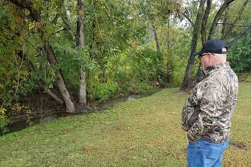 On Oct. 25, 2019, Texarkana, Arkansas, Animal Services Director Charles Lokey examines where feral hogs entered a backyard in the 6100 block of Timbercreek Drive. Hogs that live in wooded areas within the city limits regularly cause problems for residents by approaching homes to find an easy meal.