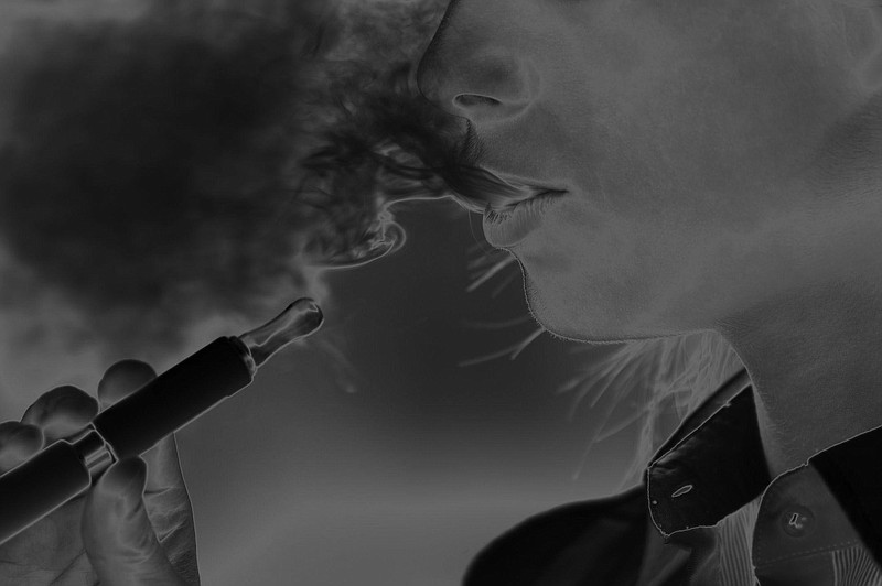 A woman smokes an e-cigarette. (File photo)