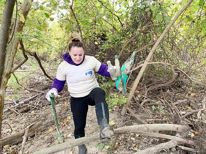 Sammy Gerb, of Columbia, cleans up trash on the bank of the Missouri River. Gerb was one of almost 200 volunteers Saturday, Oct. 26, 2019, at the Missouri River Clean-Up.