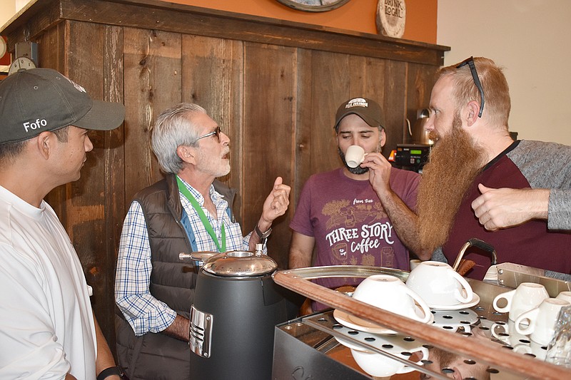 From left, Jose McEntee, Mario Valiente Sr. and Mario Valiente Jr. chat with Justin McClain, operations manager for Three Story Coffee, over expresso Sunday at the coffee shop's Dunklin Street location. The shop sources some of its coffee from the Valientes' El Salvador farm, managed by McEntee.