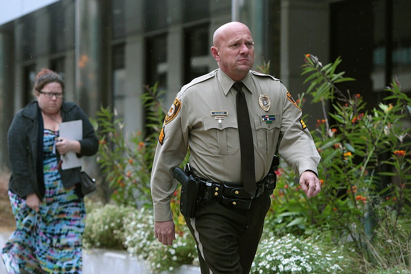 In this Oct. 24, 2019 file photo, St. Louis County police Sgt. Keith Wildhaber returns from lunch break to the St. Louis County courthouse on the third day of his discrimination case against the county in Clayton, Mo. (Cristina M. Fletes/St. Louis Post-Dispatch via AP, File)