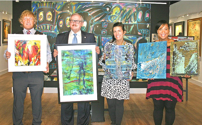 Judges for JCMOMA show off the winners of an abstract expressionism art contest for Jefferson City area high school students. From left, are Cottonstone Art Gallery & Frame Shop owner Jim Dyke holds the first-place winner, Cole County Commissioner Sam Bushman holds the second-place winner, Mayor Carrie Tergin holds the third-place winner and director of JCMOMA Chris Duren holds the two honorable mention winners. 