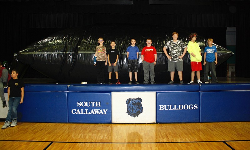 <p>Quinn Wilson/For the News Tribune</p><p>South Callaway Middle School students pose in front of the inflatable planetarium created by science teacher Joy Johnson. Johnson is a NASA solar system ambassador and got the idea from the regular online training she does in the program.</p>
