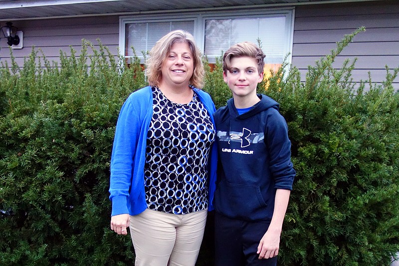 <p>Helen Wilbers/
For the News Tribune</p><p>Joshua Dillon, right, stands tall next to mother June Dillon Petree. Early this year, Dillon underwent a new type of surgery to correct his rapidly worsening scoliosis, and his family said it made all the difference.</p>
