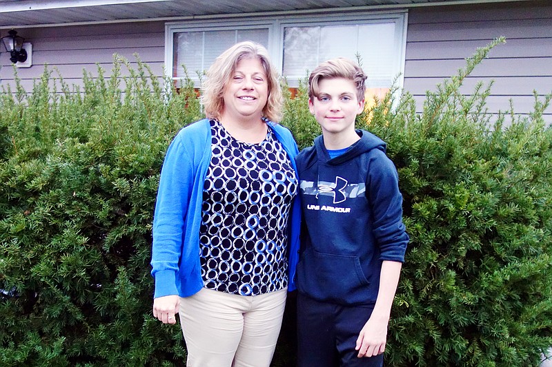 Joshua Dillon, right, stands tall next to his mother, June Dillon Petree. Early this year, Dillon underwent a new type of surgery to correct his rapidly worsening scoliosis, and his family said it made all the difference.