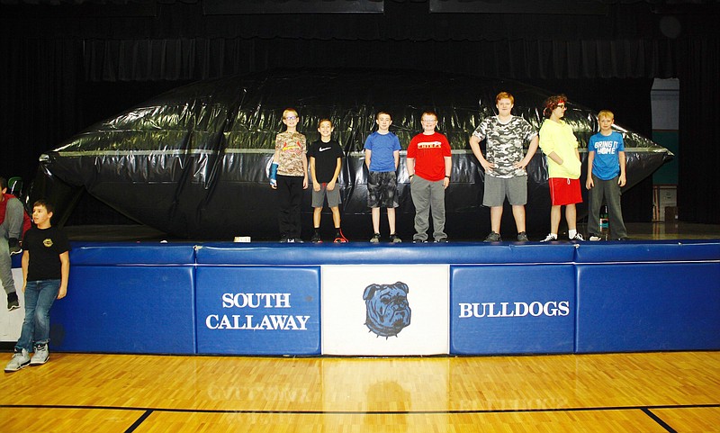 South Callaway Middle School students pose in front of the inflatable planetarium created by sixth- and seventh-grade science teacher Joy Johnson. Johnson is a NASA solar system ambassador and got the idea from the regular online training she does in the program.