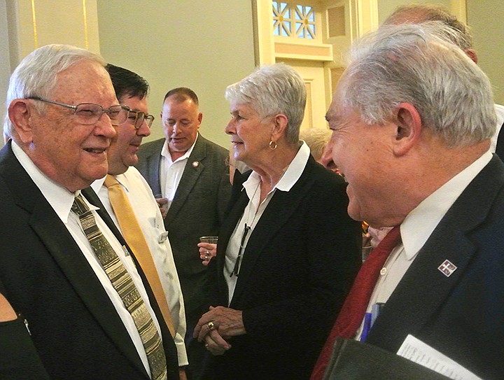 Speaking with retiring Bowie County Judge James Carlow, left, is Atlanta, Texas, attorney Marvin Weems. At Carlow's side and shaking hands with Marie Martin of Congressman Max Sandlin's office is Atlanta native Eric Cain, vice president for business at State Bank. Cain coordinated the reception for Carlow. In the background is Bowie County Commissioner Tom Whitten.
