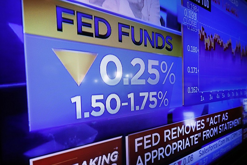 A television screen on the floor of the New York Stock Exchange shows the rate decision of the Federal Reserve, Wednesday, Oct. 30, 2019. The Federal Reserve has cut its benchmark interest rate for the third time this year to try to sustain the economic expansion in the face of global threats. (AP Photo/Richard Drew)