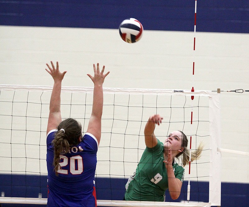 Blair Oaks outside hitter Elsie Villmer tries to spike the ball past California's Kaitlyn Stauffer during the second set of Wednesday's Class 3 District 10 championship match at California.