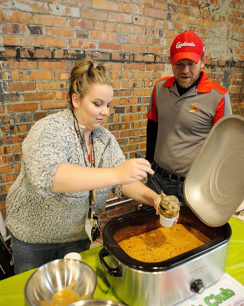 Chelsea Wood and David Thompson dish up chili for the Sam's Club team during the Big Brothers Big Sisters of Jefferson City 12th annual Chili Cook-Off. The event is one of BBBS's biggest fundraisers.