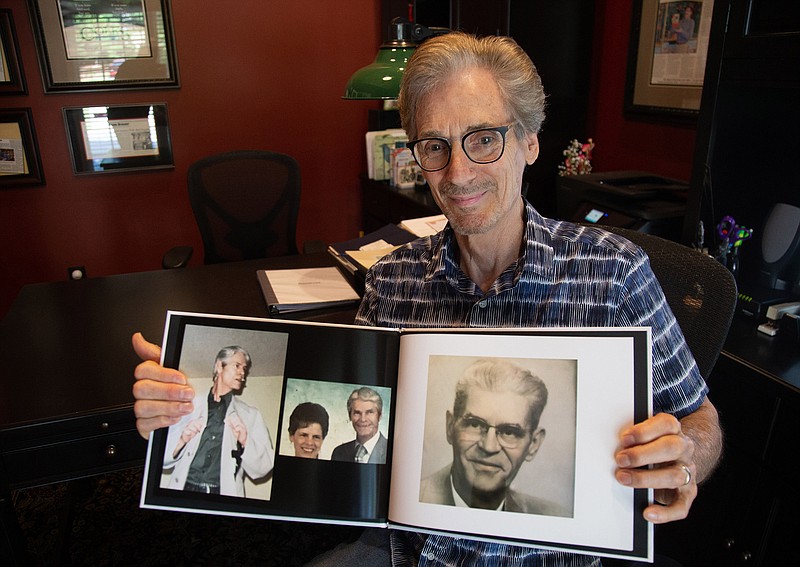 Richard Cole holds up a photograph of his newly discovered grandfather in his Kennesaw home on Sept. 17, 2019. (Steve Schaefer/Atanta Journal-Constitution/TNS) 