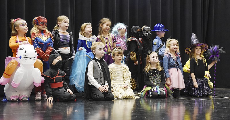 Julie Smith/News Tribune
Elementary students at St. Joseph Cathedral School pose for a group photograph as they at the conclusion of the school's Halloween costume parade in the school's gymnasium and stage. Each grade took to the stage to show their costumes, all to applause by fellow students, parents and grandparents. Many of the costumes are homemade and are inventive, creative and original. Numerous purchased ones have added pieces to make it unique to the child. After the parade of costumes, students went to the undercroft for the school's mission party. 