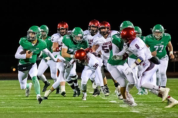 Blair Oaks quarterback Dylan Hair (left) breaks through the line and finds open running room in the first quarter of the Falcons' Homecoming game last month against Southern Boone at the Falcon Athletic Complex in Wardsville.