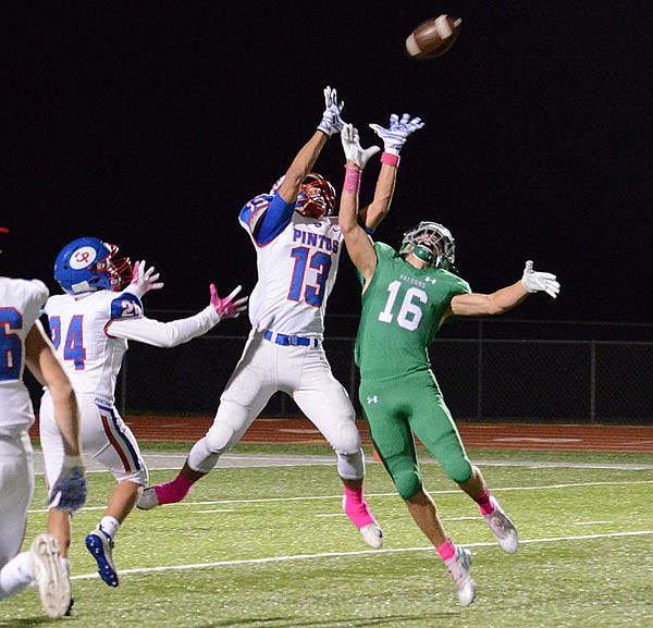 Clayton Winkler of California and Jake Closser of Blair Oaks jump for the ball during last Friday night's game in Wardsville.