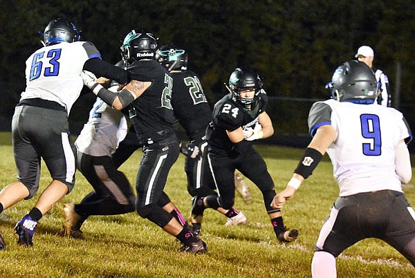 North Callaway junior running back Cody Cash looks to slip through a hole at the line of scrimmage during the Thunderbirds' 26-23 win against South Callaway in the annual Callaway Cup rivalry game last Friday in Kingdom City.
