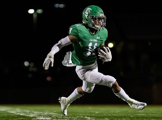 Blair Oaks wide receiver Cobi Marble looks for room to run after making a catch during Friday night's game against St. James in Wardsville.