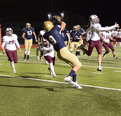 Damon Johanns of Helias catches a touchdown pass in the final minute of the first half in Friday night's game against Rolla at Ray Hentges Stadium.