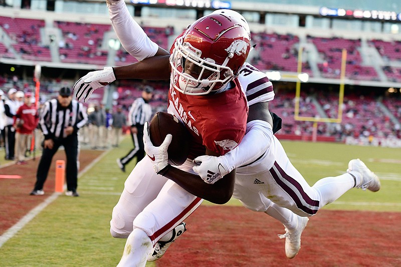 Arkansas receiver Mike Woods pulls in a touchdown catch in front of Mississippi State defender Jay Jimison in the second half of an NCAA college football game, Saturday, Nov. 2, 2019 in Fayetteville, Ark. (AP Photo/Michael Woods)