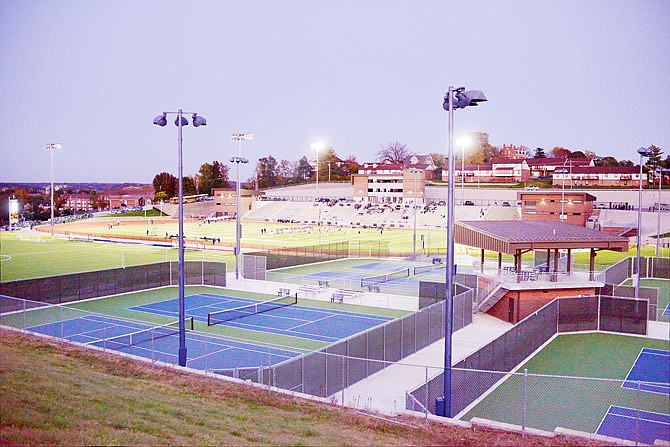 Teams warm up on the football field Friday before a game at the Helias Crusader Athletic Complex. 