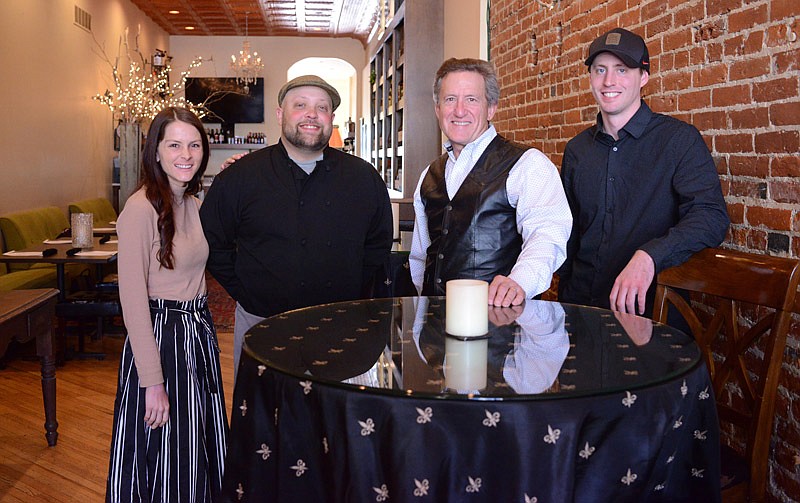 From left, Cara Alexander, chef Brian Mrozek, Mark Russell and Adam Stark stand together Thursday, Oct. 31, 2019, inside Capitol City CORK and Provisions. The partners including Sherri Russell, not pictured, recently purchased the downtown Jefferson City restaurant.