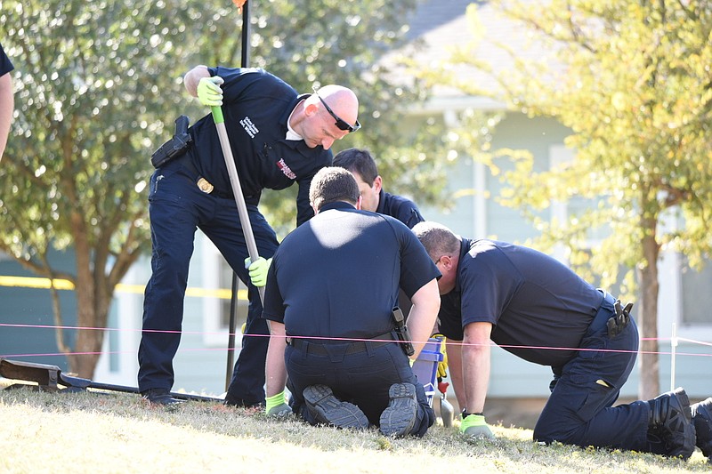 
Texarkana, Texas, Police Department officers dig a hole on Monday, Nov. 4, looking for remains of a 5-week-old baby they believe was buried in 2013 near The Oaks at Rose Hill Apartments .