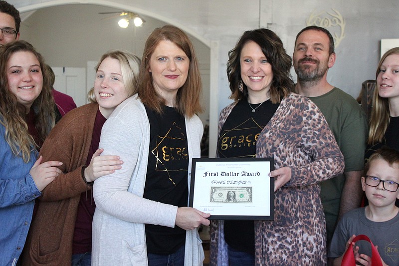Kendra Witthaus and Becki Collier accept the First Dollar from the California Chamber of Commerce for their new brick and mortar location of Grace Designs.