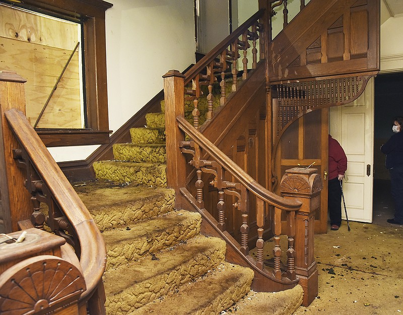 Julie Smith/News Tribune
As one enters the first floor of Ivy Terrace at 500 Capitol Ave., to the left is a beautiful, decorative solid wood staircase that leads to the second floor or the residential structure. The stairway is just one of the eye-catching visuals in the house that was open Wednesday for public tours. The city recently acquired it and has it for sale. Interested parties were allowed to get a cursory look at it Wednesday and if interested, could schedule a more detailed look next Tuesday. 