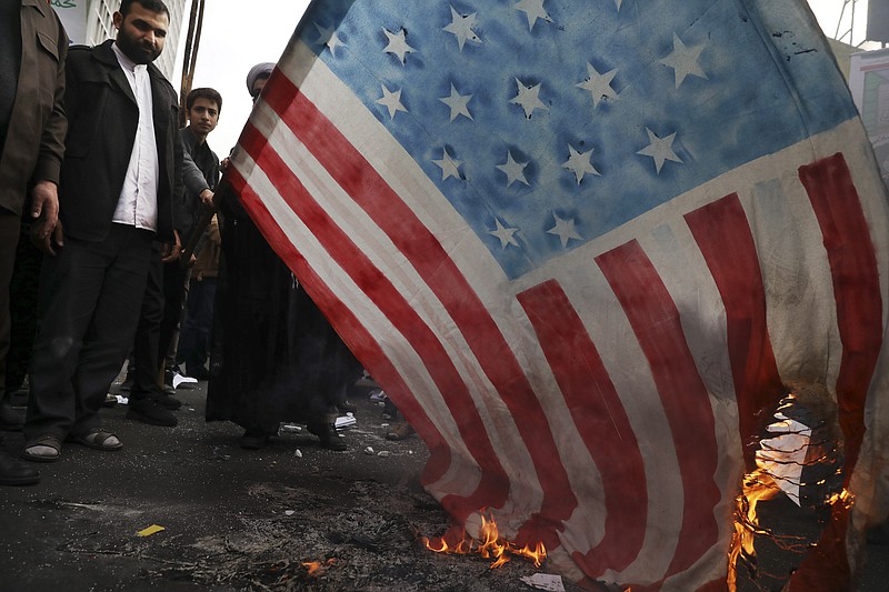 Demonstrators set fire to a rendition of the U.S. flag during a rally in front of the former U.S. Embassy in Tehran, Iran, Monday, Nov. 4, 2019. Reviving decades-old cries of "Death to America," Iran on Monday marked the 40th anniversary of the 1979 student takeover of the U.S. Embassy in Tehran and the 444-day hostage crisis that followed as tensions remain high over the country's collapsing nuclear deal with world powers. (AP Photo/Vahid Salemi)