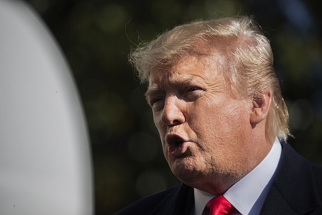 President Donald Trump speaks to reporters Sunday upon arrival at the White House in Washington.