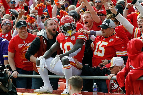 Chiefs wide receiver Tyreek Hill sits with fans after he scored a touchdown during the first half of Sunday afternoon's game against the Vikings at Arrowhead Stadium. The Chiefs won the game 26-23.