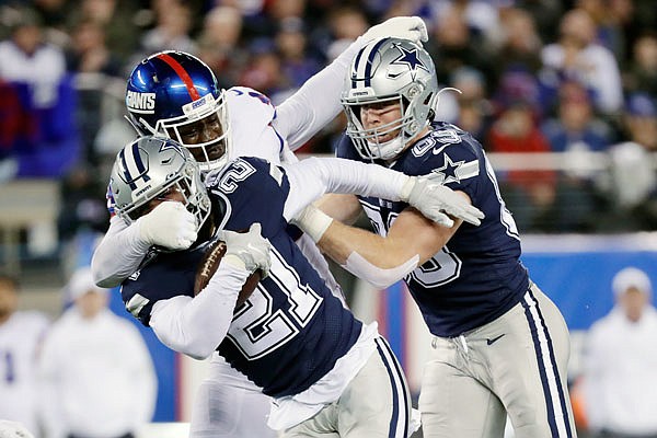 Giants linebacker Markus Golden tackles Cowboys running back Ezekiel Elliott during Monday night's game in East Rutherford, N.J. 