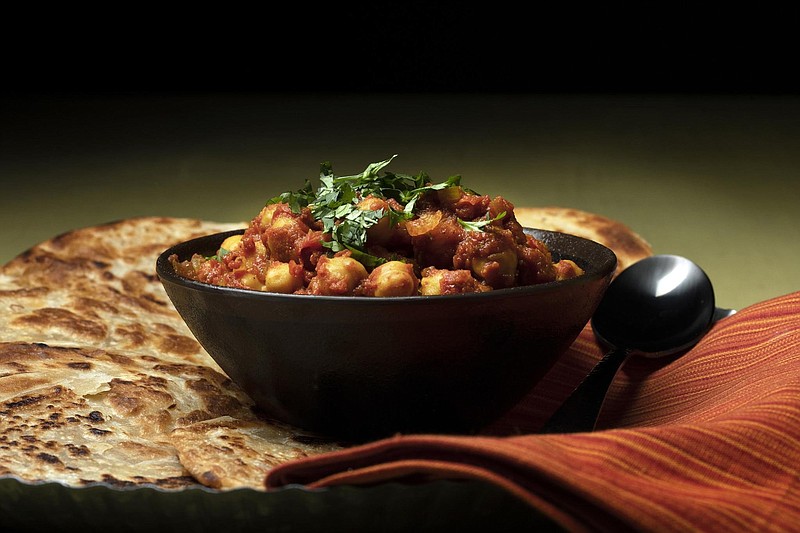 Chana masala involves cooking chickpeas in a tomato-based sauce fragrant with spices. This one includes cumin, coriander, cayenne, turmeric and for good measure, the spice blend garam masala. (Terrence Antonio James/Chicago Tribune/TNS) 