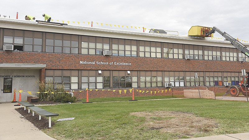 Dustin Fletcher, left, and Chad Deaver of Missouri Builders Service work to repair damaged sustained at Thorpe Gordon Elementary School in the May 22 tornado. The school, located at 1101 Jackson St., received minor damage but enough to the roof to require new materials. 